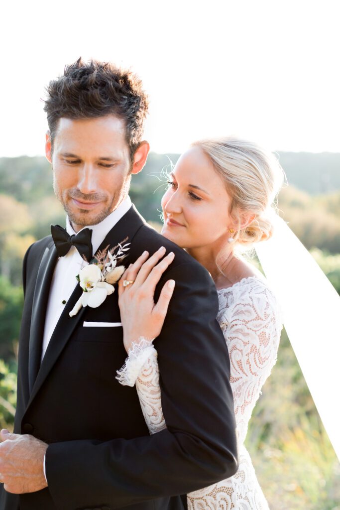 bride and groom smiling with veil