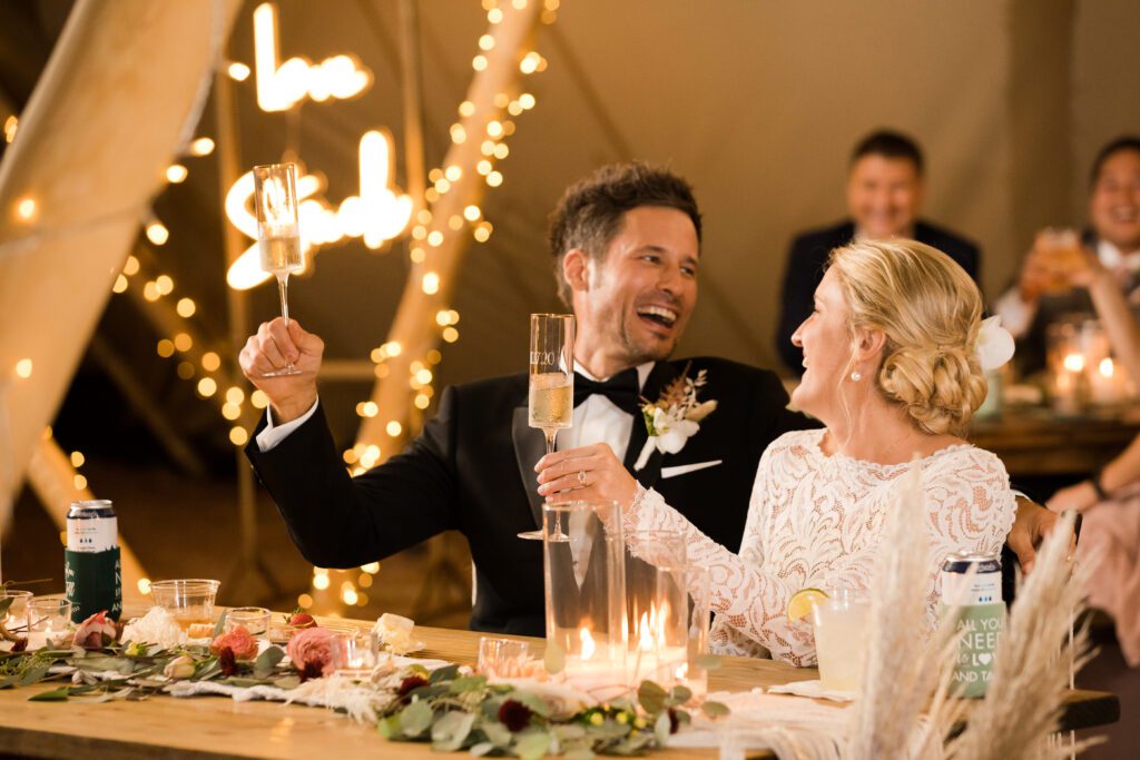 bride and groom champagne toast at night