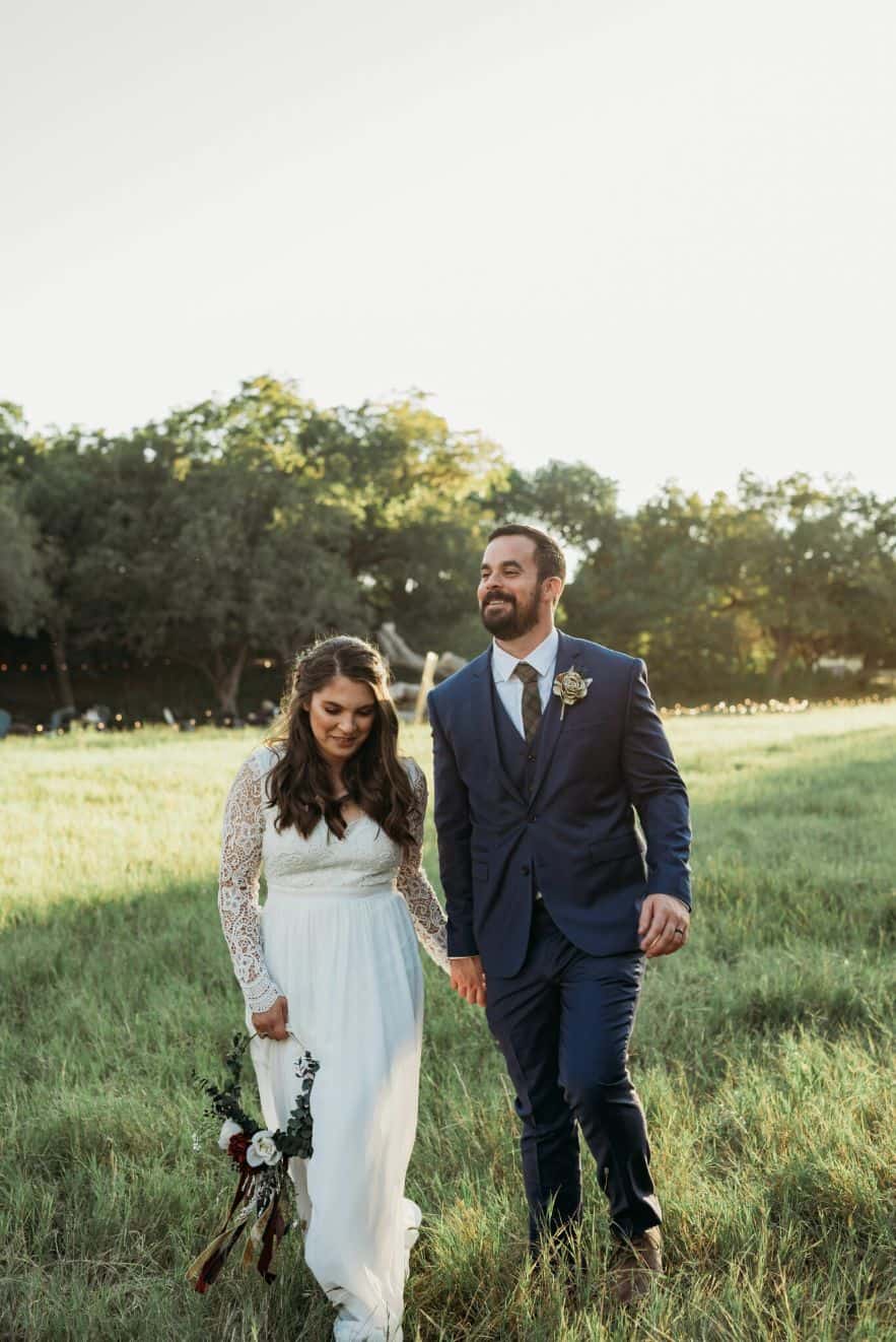 Couple in field looking down 1367x2048 elm pass woods center point texas