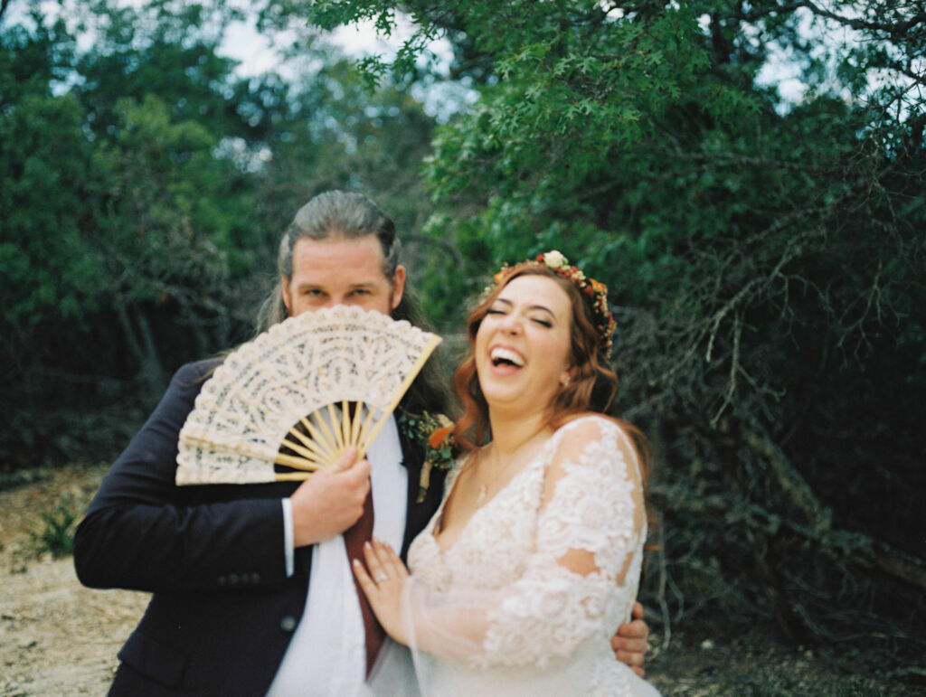 Bride and groom laugh at festival-style wedding