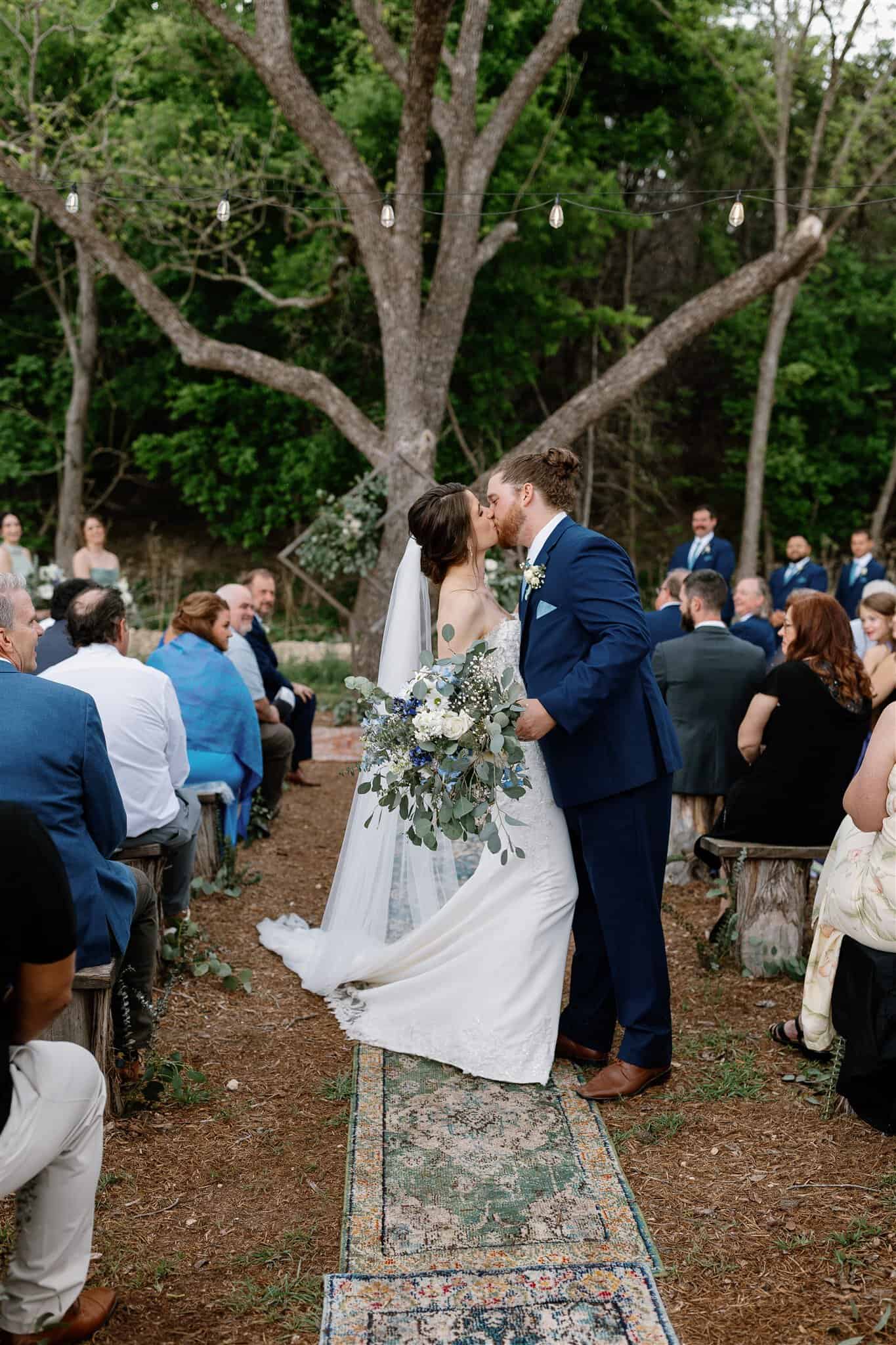 Outdoor wedding ceremony under large trees in the Texas HIll Country